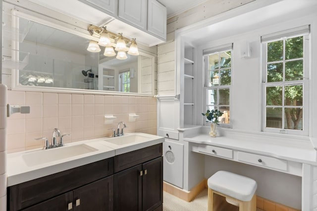 full bath with backsplash, healthy amount of natural light, a shower, and double vanity