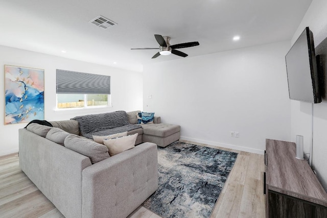 living room with ceiling fan, light wood-style floors, recessed lighting, and baseboards