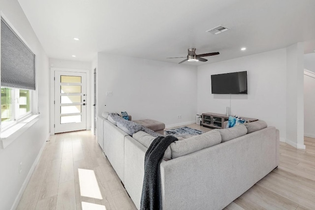living area with light wood-style floors, recessed lighting, ceiling fan, and baseboards