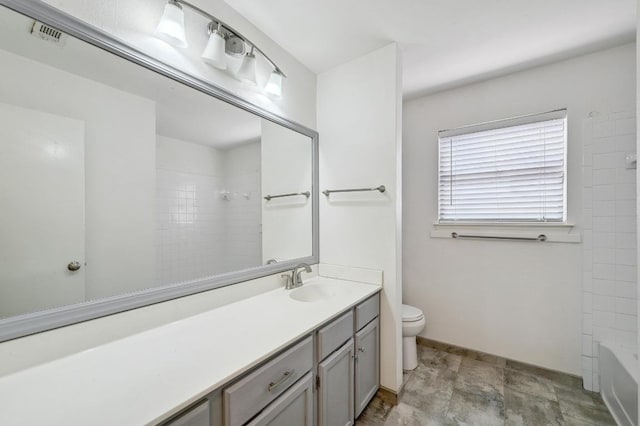 7201 Pine Bluffs Trl, Austin, TX 78729 - full bath featuring toilet, vanity, bathtub / shower combination, and stone finish floors