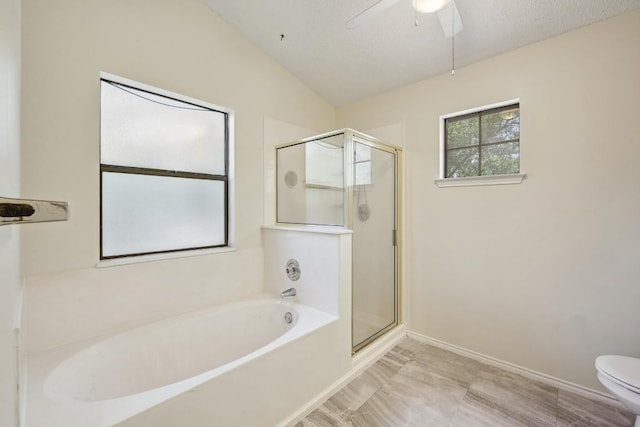 full bathroom with a stall shower, a garden tub, a ceiling fan, and toilet