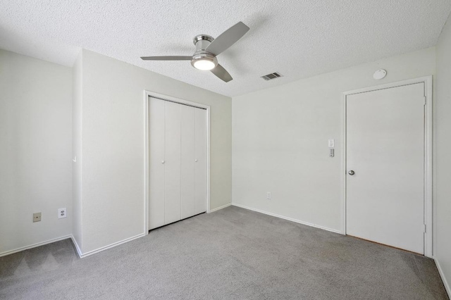 7201 Pine Bluffs Trl, Austin, TX 78729 - unfurnished bedroom with carpet flooring, a textured ceiling, a closet, ceiling fan, and baseboards