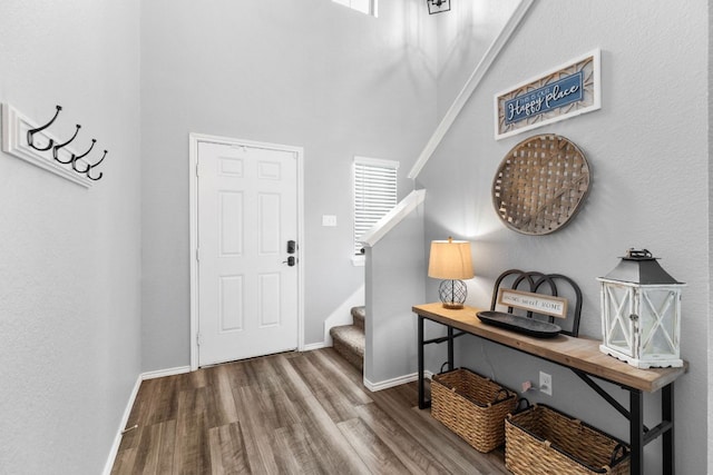109 Reagor Dr, Taylor, TX 76574 - foyer featuring wood finished floors, stairs, a towering ceiling, and healthy amount of natural light
