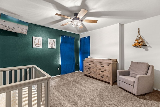 109 Reagor Dr, Taylor, TX 76574 - bedroom with carpet, a crib, a textured wall, and ceiling fan
