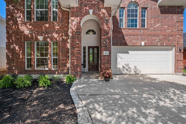 1532 Lorson Loop, Round Rock, TX 78665 - entrance to property featuring brick siding, driveway, and an attached garage