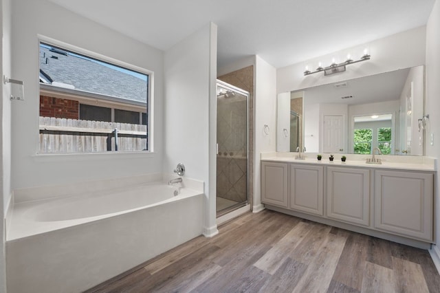 1532 Lorson Loop, Round Rock, TX 78665 - full bath with a stall shower, wood finished floors, a bath, and double vanity