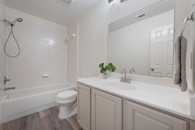 1532 Lorson Loop, Round Rock, TX 78665 - bathroom featuring wood finished floors, toilet, vanity, and  shower combination