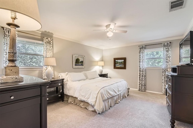 bedroom featuring light colored carpet, ornamental molding, baseboards, and a ceiling fan
