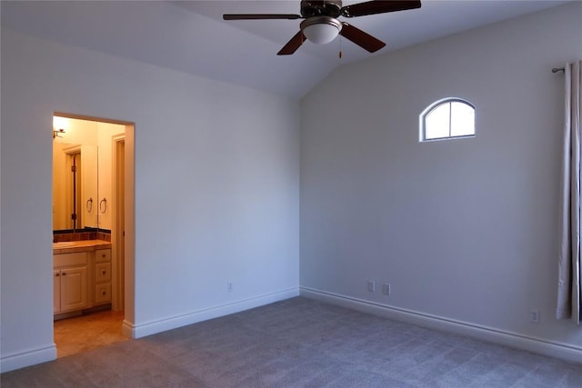 7228 Oak Shores Dr, Austin, TX 78730 - unfurnished bedroom with carpet, lofted ceiling, ensuite bathroom, baseboards, and ceiling fan