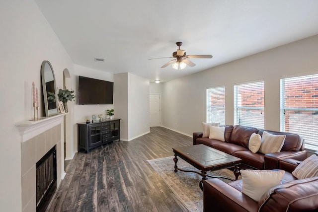 232 Housefinch Loop, Leander, TX 78641 - living area with ceiling fan, dark wood-style flooring, and a fireplace