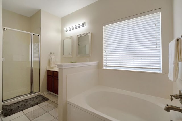 bathroom with vanity, a stall shower, and a garden tub