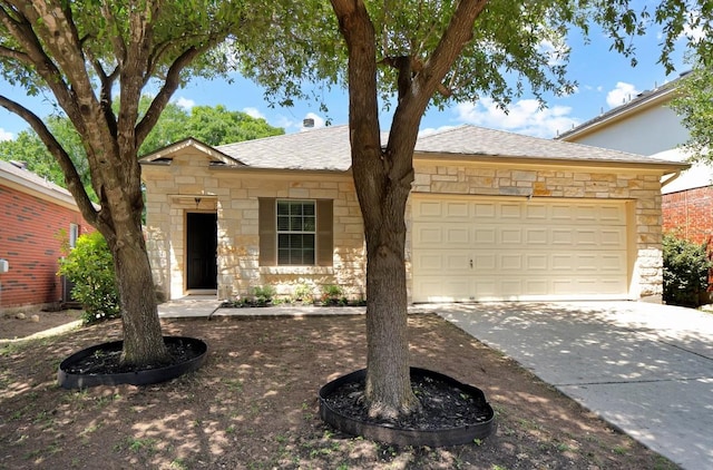 232 Housefinch Loop, Leander, TX 78641 - ranch-style house with stone siding, an attached garage, concrete driveway, and a shingled roof