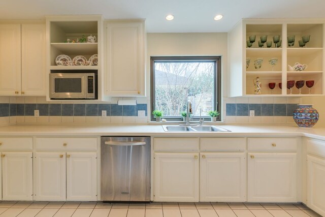 2403 Braemar Cv, Austin, TX 78747 - kitchen with appliances with stainless steel finishes, a sink, open shelves, white cabinets, and light countertops