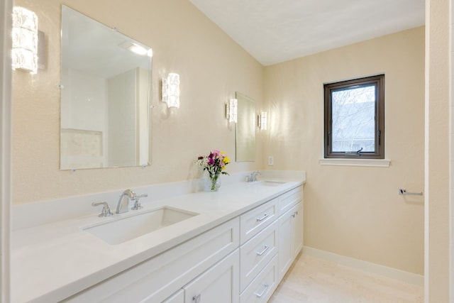 2403 Braemar Cv, Austin, TX 78747 - bathroom with double vanity and baseboards