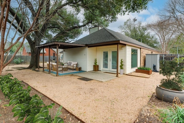 2403 Braemar Cv, Austin, TX 78747 - back of house featuring french doors, a patio, a fenced backyard, and roof with shingles