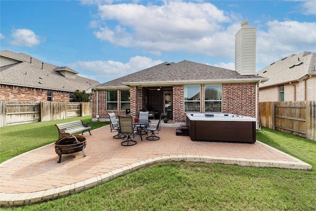 4216 Hannover Way, Round Rock, TX 78681 - rear view of property with a fire pit, a hot tub, and a patio