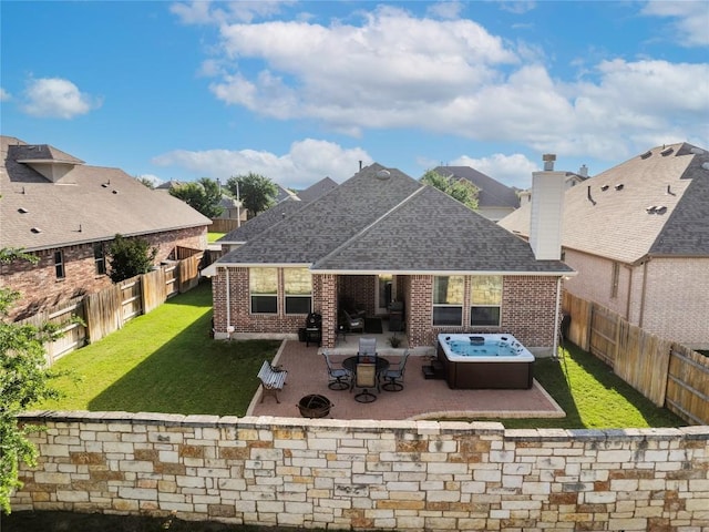 4216 Hannover Way, Round Rock, TX 78681 - rear view of property featuring roof with shingles, brick siding, a hot tub, and a patio area