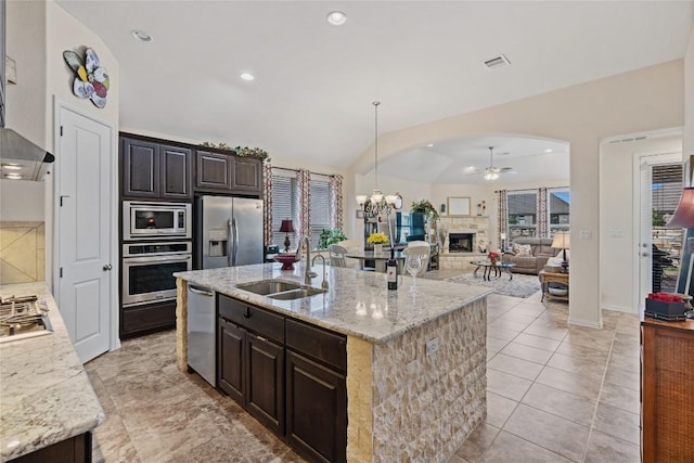 4216 Hannover Way, Round Rock, TX 78681 - kitchen featuring appliances with stainless steel finishes, a sink, ceiling fan, an island with sink, and light stone counters