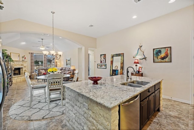 4216 Hannover Way, Round Rock, TX 78681 - kitchen featuring a sink, arched walkways, dishwasher, ceiling fan, and open floor plan