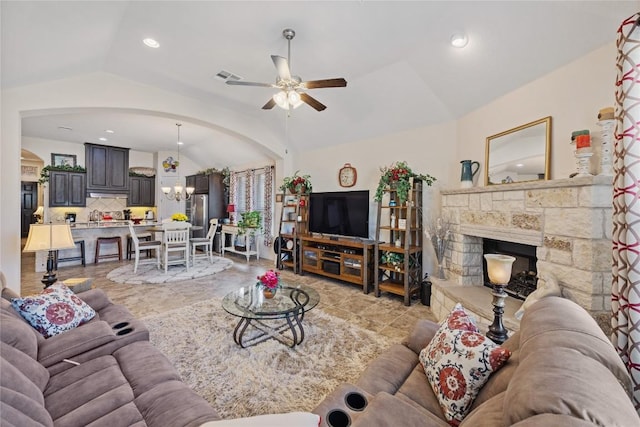 4216 Hannover Way, Round Rock, TX 78681 - living room featuring vaulted ceiling, ceiling fan, a stone fireplace, a chandelier, and arched walkways