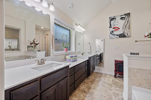 4216 Hannover Way, Round Rock, TX 78681 - full bath with lofted ceiling, double vanity, a tub, and baseboards