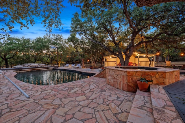 19905 Hamilton Pool Rd, Dripping Springs, TX 78620 - pool at dusk featuring a patio, an in-ground hot tub, and an outdoor pool