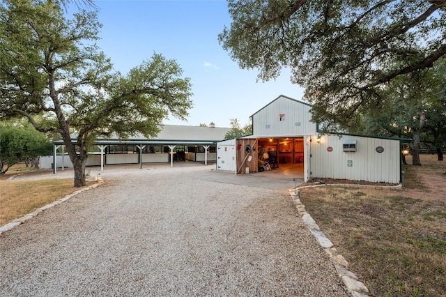 19905 Hamilton Pool Rd, Dripping Springs, TX 78620 - view of front of property with driveway, a carport, an outdoor structure, and a pole building