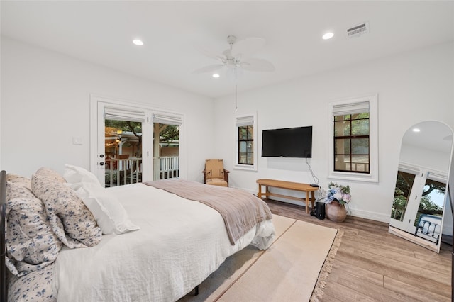 19905 Hamilton Pool Rd, Dripping Springs, TX 78620 - bedroom with access to outside, wood finished floors, recessed lighting, multiple windows, and baseboards