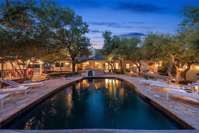 19905 Hamilton Pool Rd, Dripping Springs, TX 78620 - pool at dusk featuring a patio area and an outdoor pool