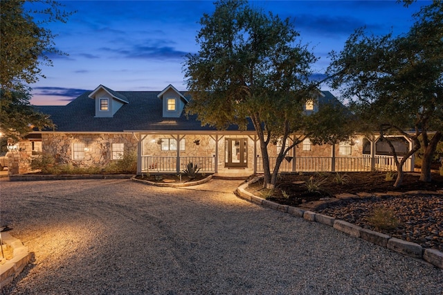 19905 Hamilton Pool Rd, Dripping Springs, TX 78620 - new england style home featuring stone siding and a porch