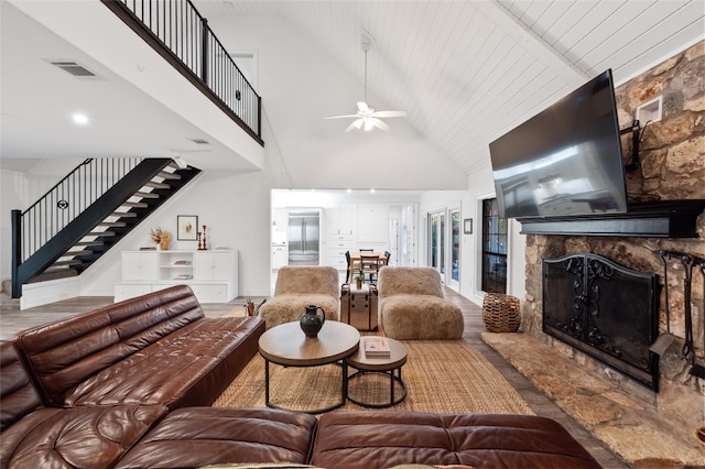 19905 Hamilton Pool Rd, Dripping Springs, TX 78620 - living room featuring a fireplace, stairway, high vaulted ceiling, ceiling fan, and wood finished floors