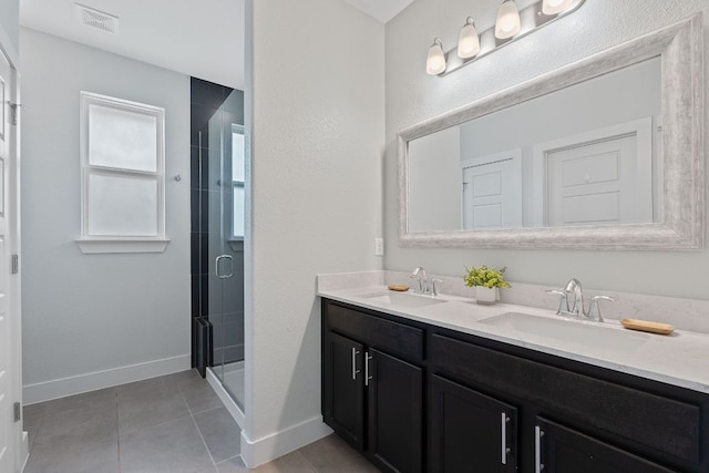 6008 Rubicon Run, Austin, TX 78745 - full bath featuring double vanity, a shower stall, tile patterned flooring, and baseboards