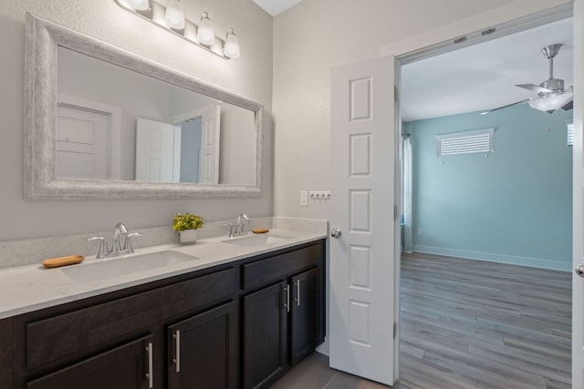 6008 Rubicon Run, Austin, TX 78745 - full bathroom featuring double vanity, a ceiling fan, wood finished floors, and baseboards