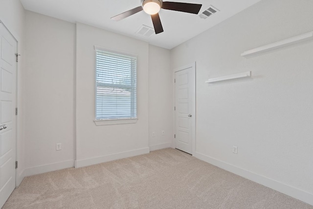 unfurnished bedroom featuring light carpet, baseboards, and ceiling fan