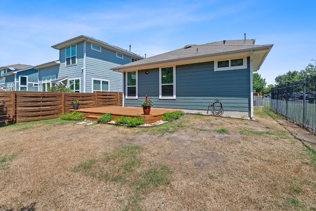 rear view of house featuring a wooden deck