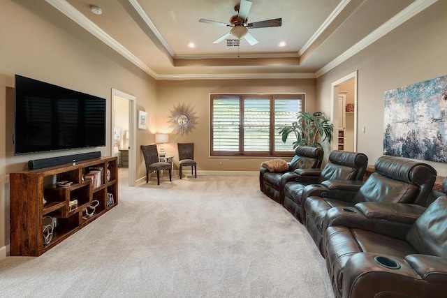 living room with a raised ceiling, carpet floors, ceiling fan, ornamental molding, and baseboards
