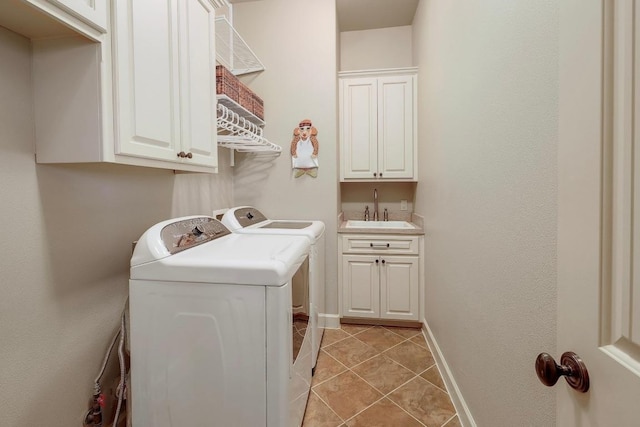 laundry room with independent washer and dryer, cabinet space, bar with sink, light tile patterned floors, and baseboards