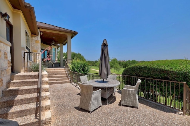 view of patio with outdoor dining area and ceiling fan