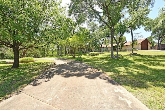 107 Phalarope Dr, Buda, TX 78610 - view of home's community featuring a lawn and driveway