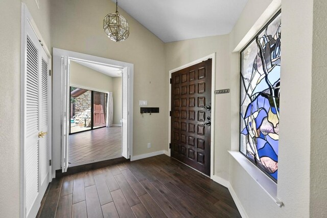 107 Phalarope Dr, Buda, TX 78610 - entryway with baseboards, dark wood finished floors, a chandelier, and lofted ceiling