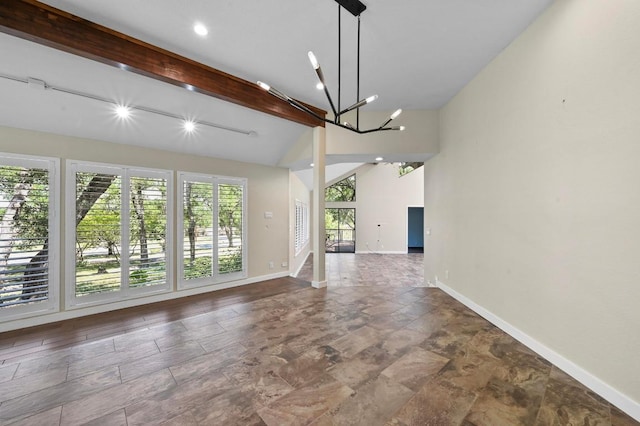 107 Phalarope Dr, Buda, TX 78610 - unfurnished living room featuring a chandelier and baseboards