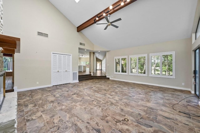 107 Phalarope Dr, Buda, TX 78610 - unfurnished living room featuring a ceiling fan, high vaulted ceiling, rail lighting, baseboards, and beam ceiling