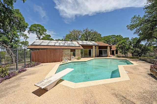 107 Phalarope Dr, Buda, TX 78610 - view of swimming pool with a patio area, fence, and a diving board