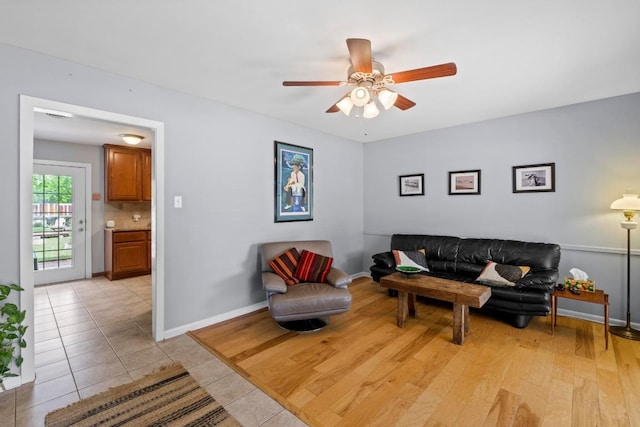 7912 Burrell Dr, Austin, TX 78757 - living area with ceiling fan, light tile patterned floors, and baseboards