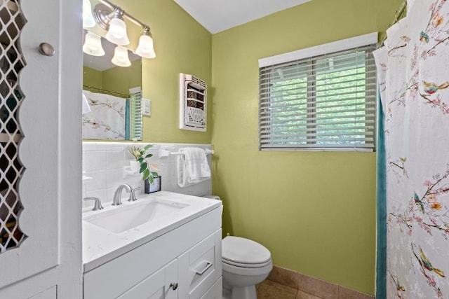 7912 Burrell Dr, Austin, TX 78757 - bathroom featuring tile patterned floors, toilet, vanity, and tile walls