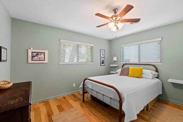7912 Burrell Dr, Austin, TX 78757 - bedroom with wood finished floors, a ceiling fan, and baseboards