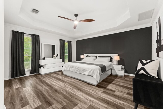 7016 Bending Oak Rd, Austin, TX 78749 - bedroom with a tray ceiling, wood finished floors, crown molding, and a ceiling fan