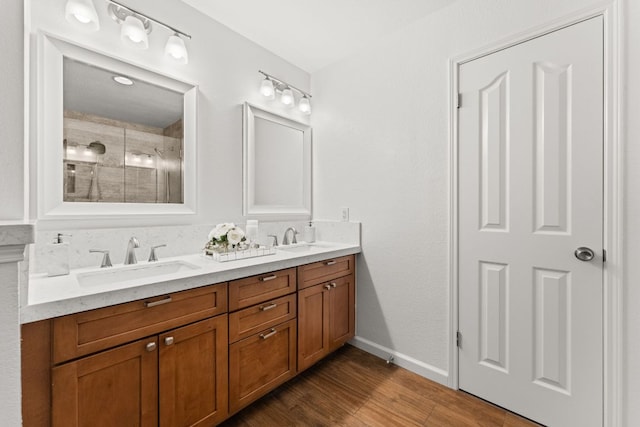 7016 Bending Oak Rd, Austin, TX 78749 - bathroom featuring wood finished floors, a shower stall, double vanity, and baseboards