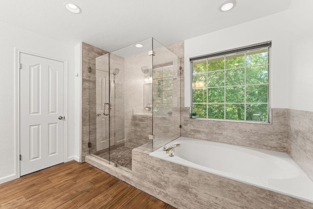 7016 Bending Oak Rd, Austin, TX 78749 - full bathroom featuring a stall shower, a garden tub, wood finished floors, and recessed lighting