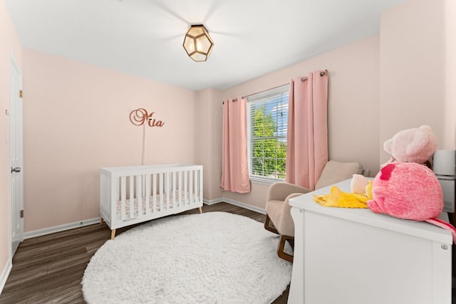 7016 Bending Oak Rd, Austin, TX 78749 - bedroom featuring dark wood-type flooring, baseboards, and a crib